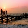 people standing on dock during sunrise